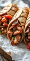 Savory grilled wraps filled with marinated meat and fresh vegetables on a wooden serving tray photo