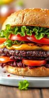 Juicy burger stacked with layers of cheese, lettuce, and fresh tomatoes served on a bun at a casual dining location photo