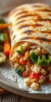 Grilled vegetable wrap filled with quinoa and fresh greens on a rustic plate photo