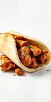 Delicious chicken wrap filled with marinated grilled chicken and spices on a light background photo