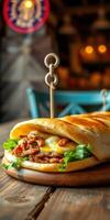 Savory sandwich with grilled chicken, melted cheese, and fresh lettuce served on a rustic wooden table photo