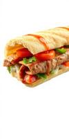 Delicious meat sandwich with fresh vegetables and sauce on a crusty baguette photo