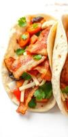 Delicious tacos filled with bacon, fresh vegetables, and herbs served on a tortilla photo