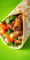 Grilled meat wrap with fresh vegetables served on a vibrant green background photo