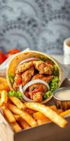 Delicious wrap filled with crispy chicken, fresh vegetables, and golden fries served in a cozy setting photo