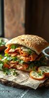 Flavorful layered sandwich with fresh herbs and crispy ingredients prepared on rustic wooden table photo
