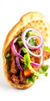 Delicious pita wrap filled with savory seasoned meat and fresh vegetables from a local eatery photo