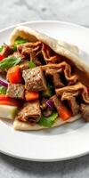 Savory kebab wrap filled with tender beef, fresh vegetables, and herbs on a white plate photo