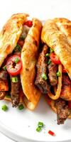 Delicious spiced grilled meat in soft flatbreads topped with fresh vegetables and herbs photo