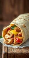 Delicious wrap filled with grilled chicken, vegetables, and cheese enjoyed on a rustic wooden table photo
