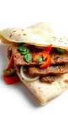Flavorful grilled meat wrap with fresh vegetables and herbs in a soft tortilla photo