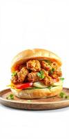 Crispy chicken sandwich served on a wooden plate with fresh vegetables and herbs for a tasty meal photo