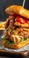 Deliciously stacked sandwich filled with chicken, cheese, tomatoes, and noodles presented on a wooden board photo