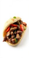 Savory grilled meat wrapped in warm flatbread with fresh vegetables and herbs prepared in a kitchen setting photo