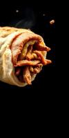 Delicious wrap filled with grilled meat and savory toppings served against a dark background photo