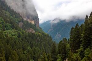 Sumela Monastery and misty mountains. Visit Trabzon background photo
