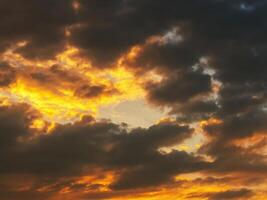 orange sunset in a cloudy sky with clouds at sunset in evening. Background with sky photo