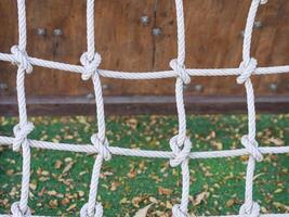 Rope net tied for climb in the playground. photo