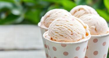 Delicious scoops of creamy ice cream in a polka dot cup photo