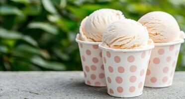 Scoops of delicious ice cream in polka dot cups photo