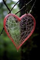 Intricate heart shaped web covered in dew photo