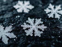 Intricate snowflake patterns on dark surface photo