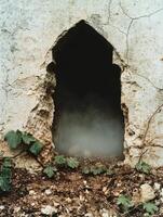 Mysterious cave entrance in rocky terrain photo