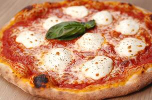Delicious homemade pizza with fresh mozzarella and basil photo