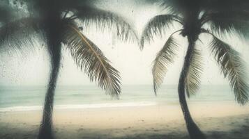 Fogged glass framing a sandy beach, distant and wistful atmosphere. Blurred view sandy beach palms photo