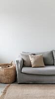 Basket with throws and cushions, blending comfort and style in living room. Wicker basket near grey sofa in living room photo