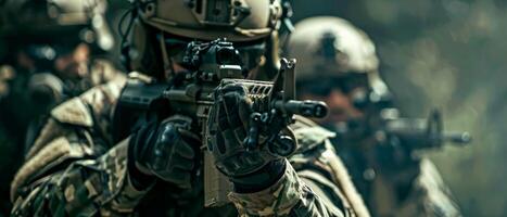 A soldier in full combat gear is aiming his rifle while advancing through a jungle. photo