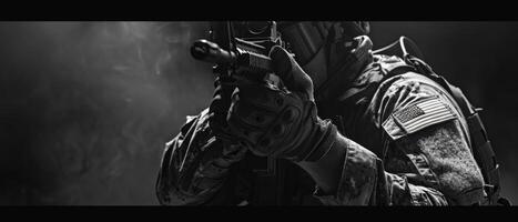 A soldier in full tactical gear is aiming his rifle. photo