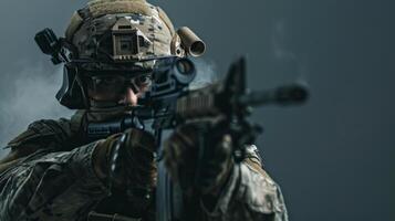 A soldier in full combat gear aims his rifle. photo