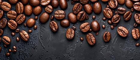 Coffee beans scattered on a dark background. Top view with copy space. photo