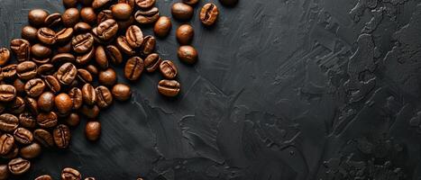 Coffee beans scattered on a black stone table. photo