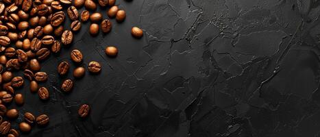 Coffee beans scattered on a black stone background. Top view with copy space. photo