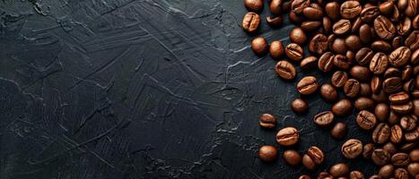 Coffee beans scattered on a black stone background. Top view. photo