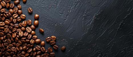 Coffee beans scattered on a dark stone background. Top view with copy space. photo