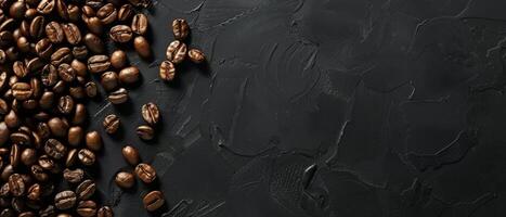 Coffee beans scattered on a black stone background. Top view. photo