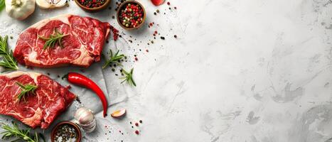 Raw fresh beef steak with spices and herbs on white background. photo