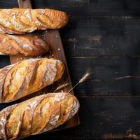 Loaf of freshly baked bread on a wooden table. photo