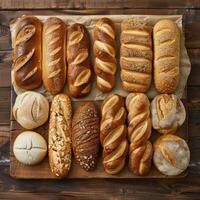 Various types of bread on a wooden table. photo