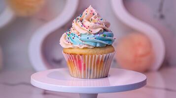 A beautifully frosted vanilla cupcake with swirls of pastel-colored buttercream and sprinkles displayed on a white stand, photography photo