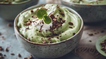 Bowl of creamy sugar-free avocado mousse topped with coconut cream and cocoa nibs, photography photo