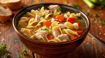 Bowl of rich chicken noodle soup with chicken carrots celery and egg noodles in savory broth, photography photo