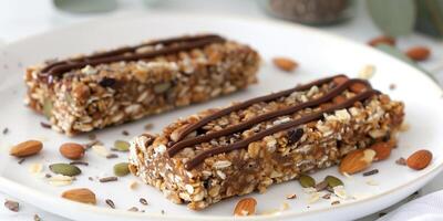 Keto granola bar filled with nuts, seeds, and a drizzle of sugar-free chocolate, photo