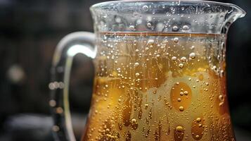 A large glass jug with fermenting ginger beer showing bubbling action at the surface, picture photo