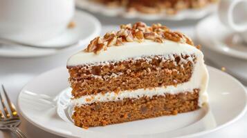 Slice of moist carrot cake with cream cheese frosting and chopped walnuts, photo
