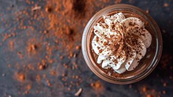 Smooth dairy-free chocolate mousse in a jar topped with coconut whipped cream and cocoa powder, photography photo