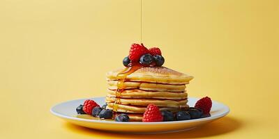 Stack of plant-based pancakes with mixed berries and maple syrup drizzle, photo